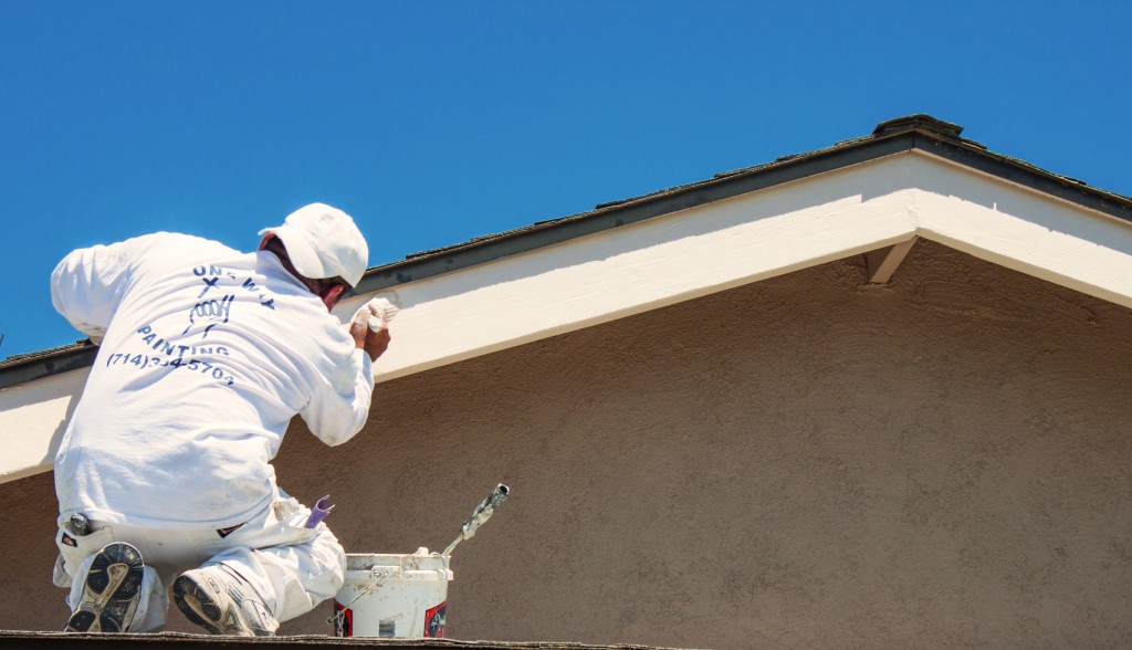 Orange County Painters from One Way Painting, painting the trim of a residential house