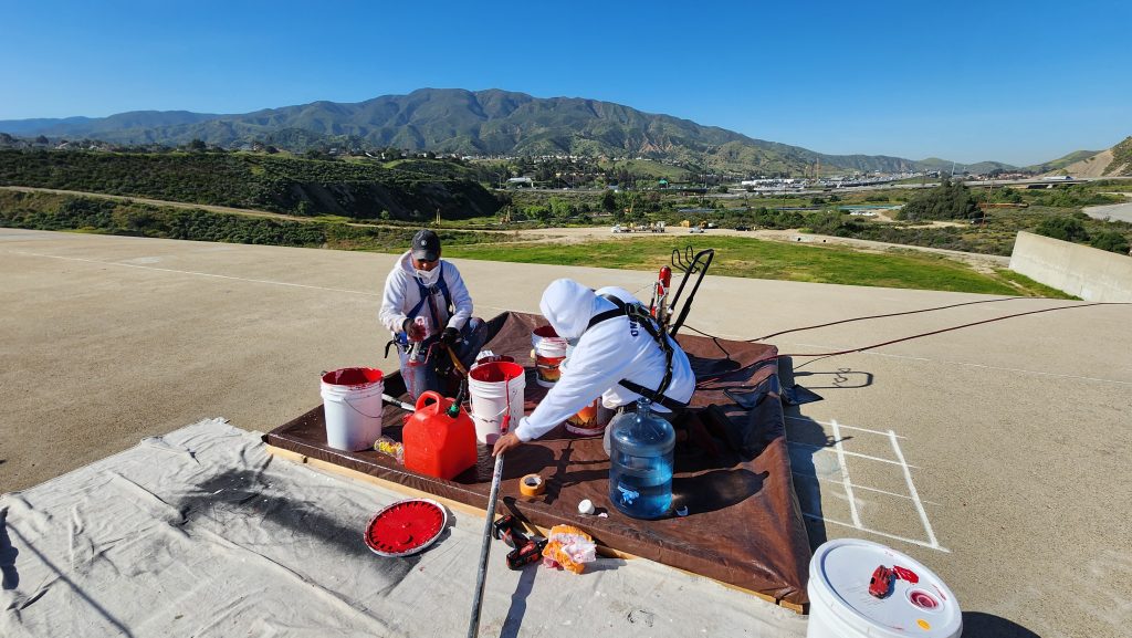 painters with paint & equipment at Prado dam for bicentennial mural restoration