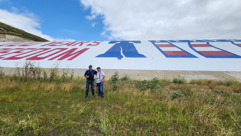 Prado Dam Mural Restoration Complete 2023: Jim and Jeff McCabe at the base of the dam