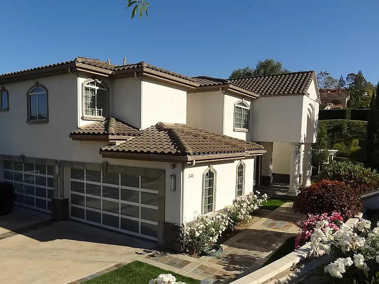 A house in Anaheim Hills freshly painted by One Way Painting, showcasing a clean and modern look with pristine white walls and dark roof tiles.