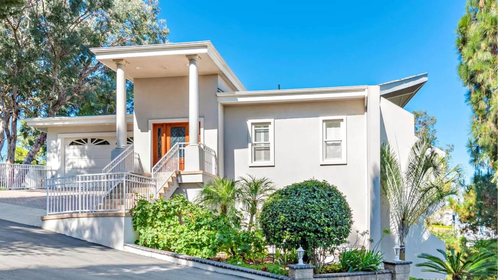 Detailed exterior work on a house in Anaheim Hills' Mohler Loop by One Way Painting. The project included prepping and painting eaves, window trim, French doors, and thresholds white; sanding and clear-coating doors and wrought iron; and priming and painting the garage door.