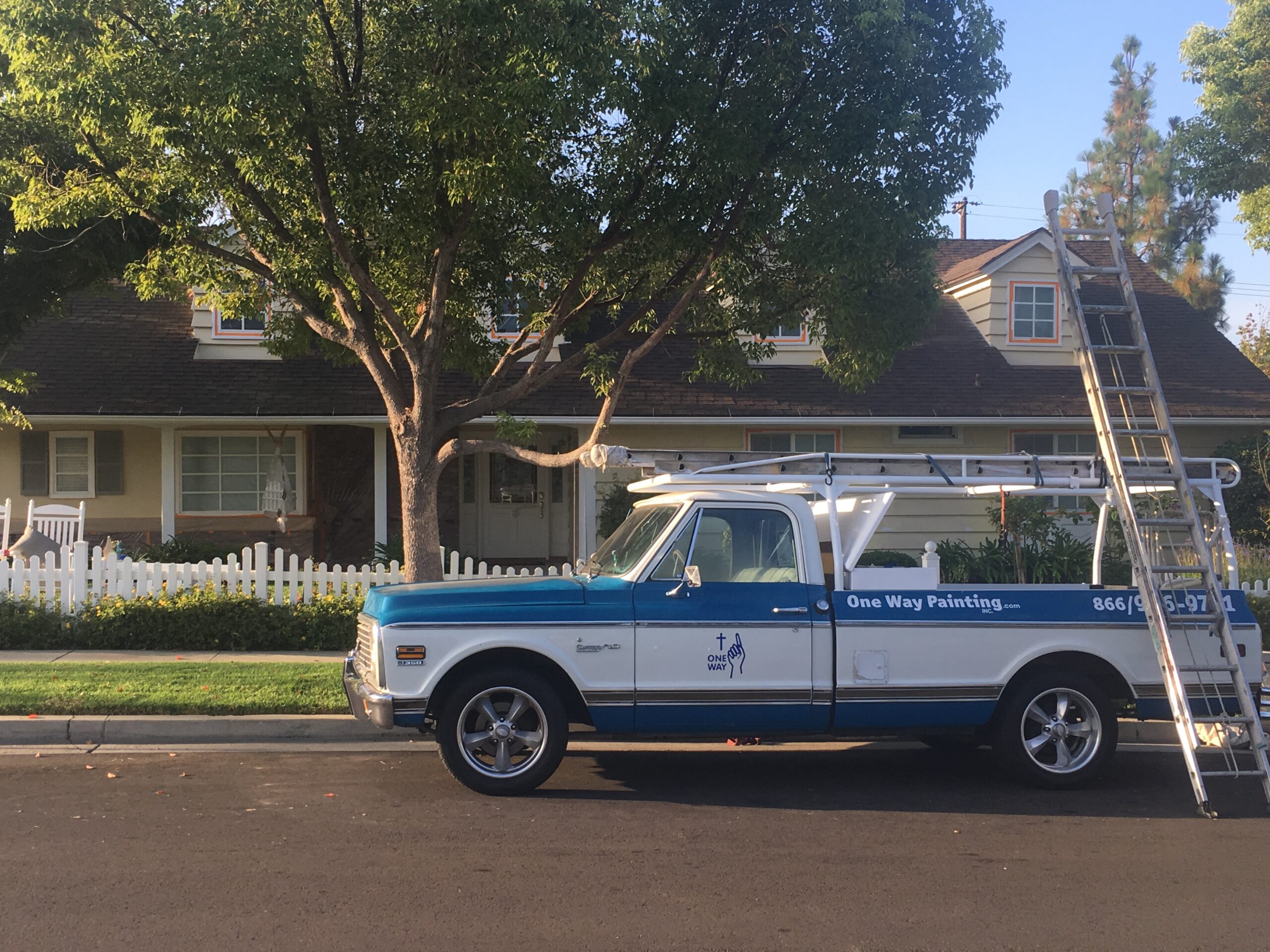 A One Way Painting truck parked outside of a home before painting.