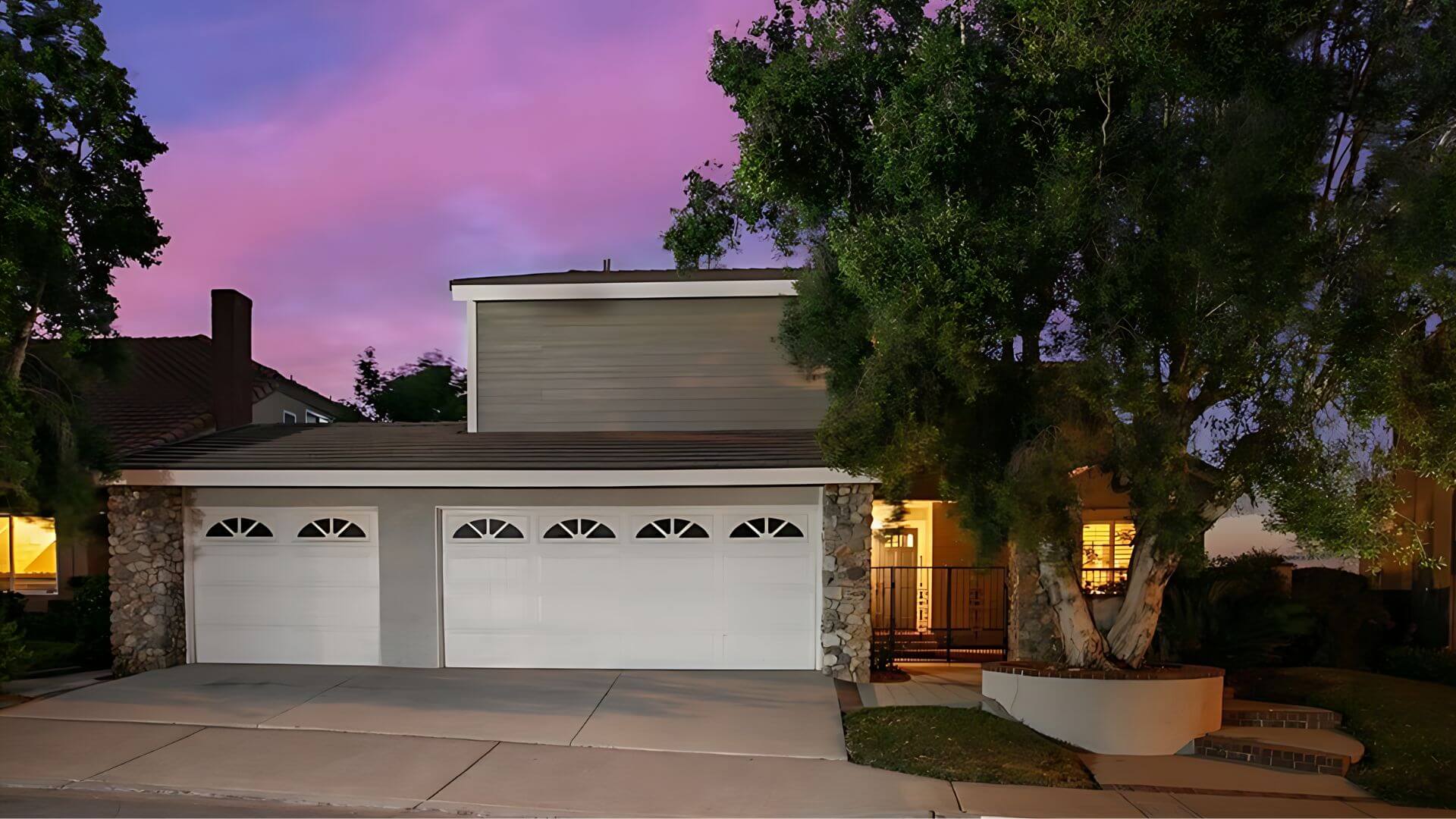 An exterior home painted by One Way Painting's exterior house painters with two garage doors, stucco and siding in Anaheim Hills, CA.