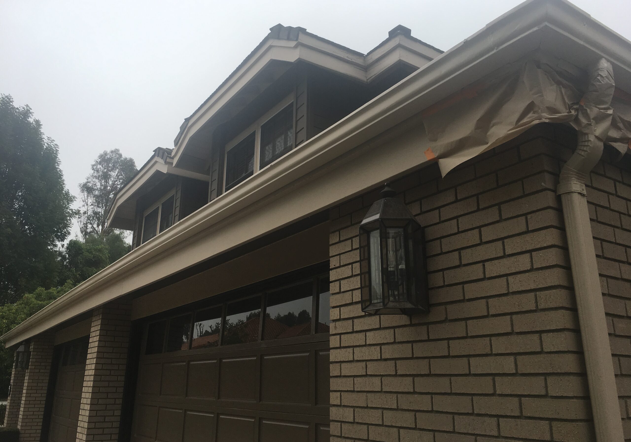 eaves and fascia and light brown after being painted and garage door dark brown color on Villa Park, CA home
